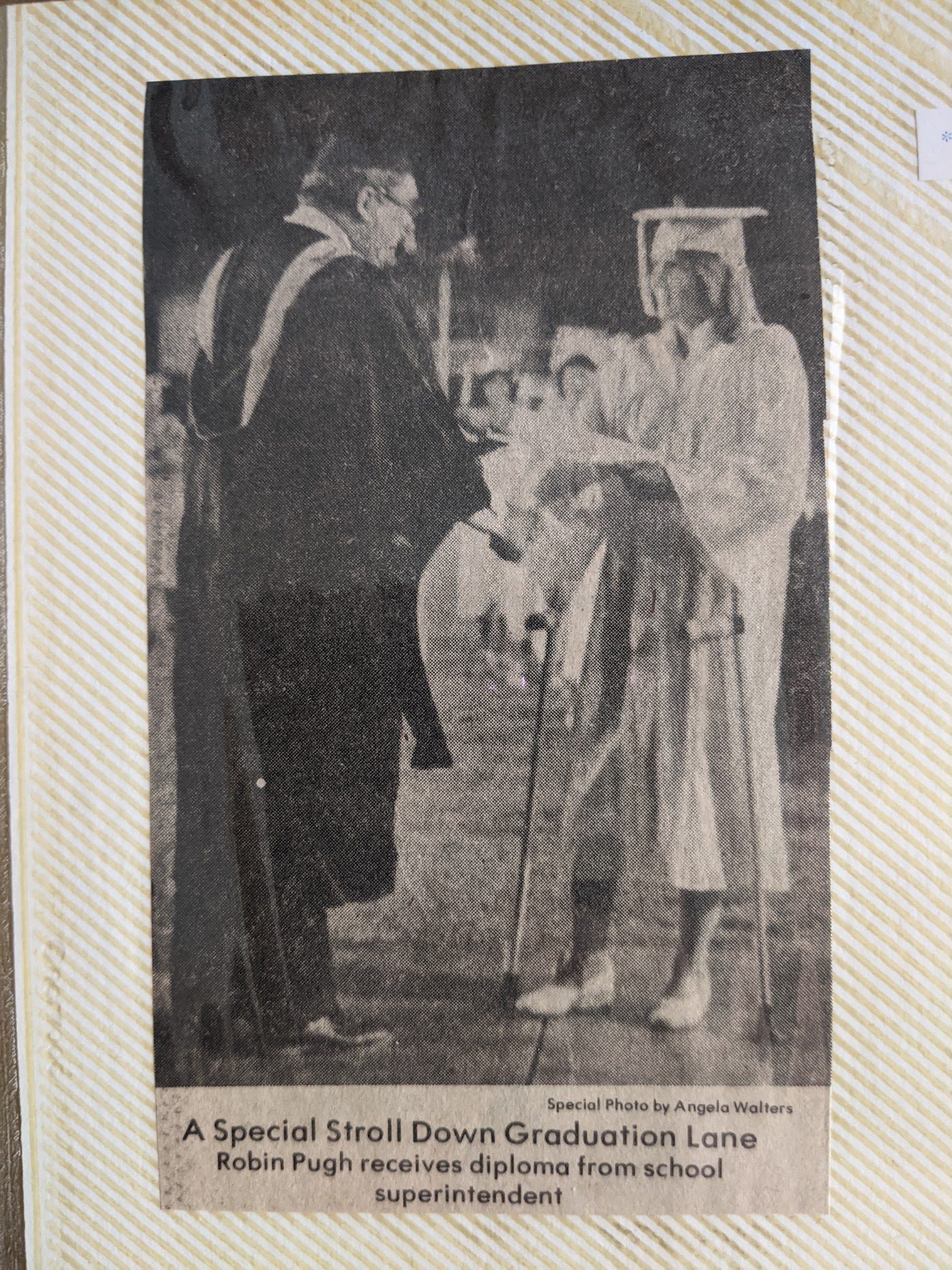 Newspaper photo of Robin receiving her diploma, 1980